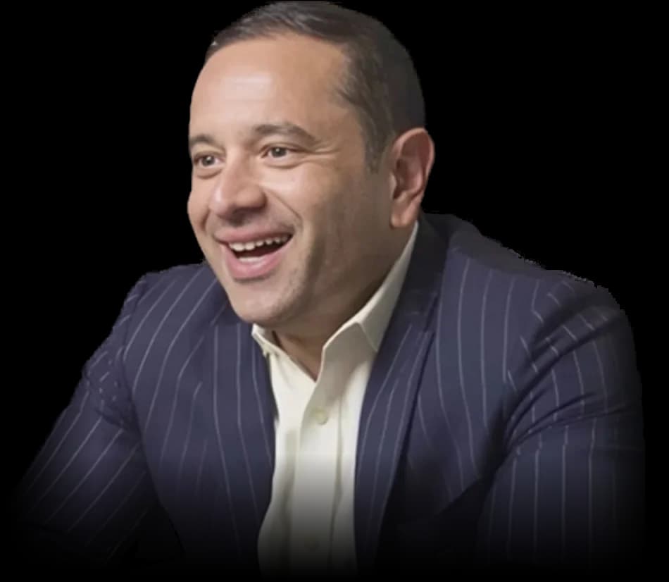 Nik Agharkar, tax and securities attorney, smiling in a navy pinstripe suit