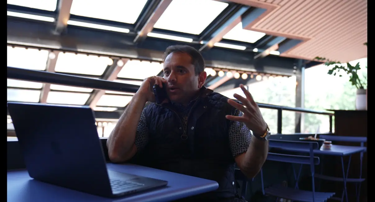 Nik Agharkar on a phone call at his laptop